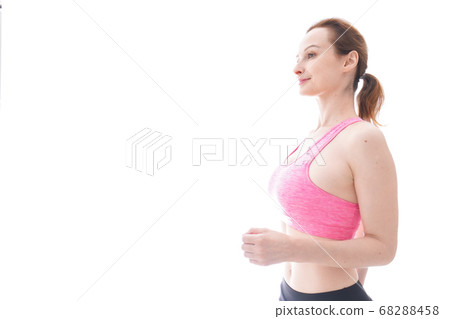 Smiling young woman running Smiling young woman running 68288458
