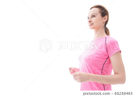 Smiling young woman running Smiling young woman running 68288465