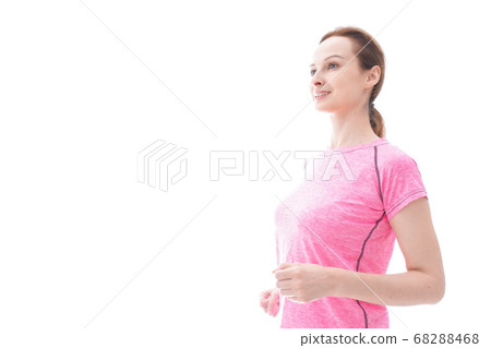 Smiling young woman running Smiling young woman running 68288468