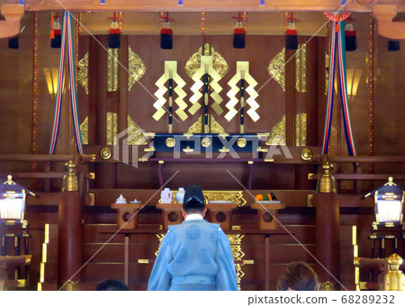 Praying at a shrine 68289232