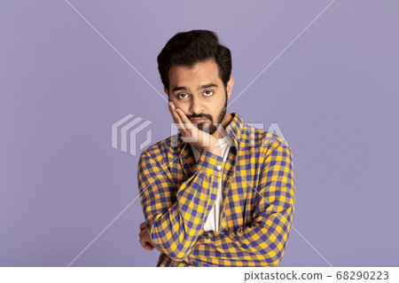 Handsome Indian man feeling bored or tired on lilac background Handsome Indian man feeling bored or tired on lilac background 68290223