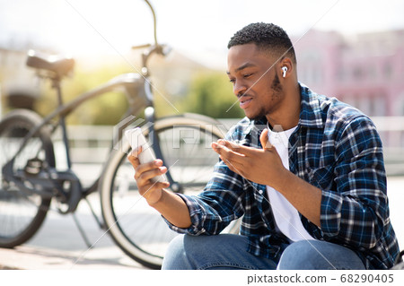 Portrait of african american guy making video call outdoor Portrait of african american guy making video call outdoor 68290405