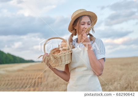 Female farmer standing wheat agricultural field 68290642