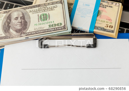 An empty form of statement and money on the table. 68290856