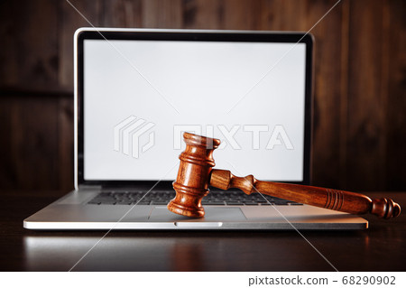 Wooden judges gavel on a computer keyboard. Cyber law and crime internet concept 68290902