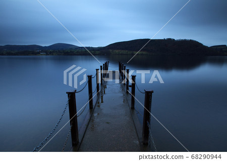 Evening Light on Ullswater. The pier is a landing stage on the banks of Ullswater, Cumbria in the English Lake District national park. Evening Light on Ullswater. The pier is a landing stage on the banks of Ullswater, Cumbria in the English Lake District national park. 68290944