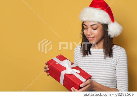 Pretty African American woman in Santa hat  68291509