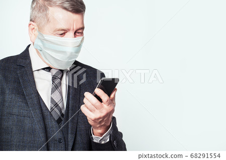 Senior man in medical protective face mask using 68291554