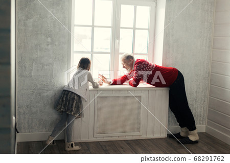 kind grandfather trying to cheer up his granddaughter kind grandfather trying to cheer up his granddaughter 68291762