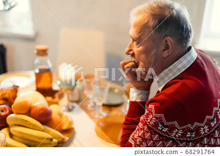 Aged depressed worried man sitting alone in the kitchen Aged depressed worried man sitting alone in the kitchen 68291764