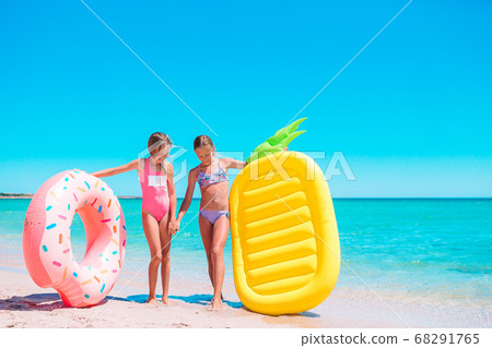 Little girls having fun at tropical beach during summer vacation playing together 68291765