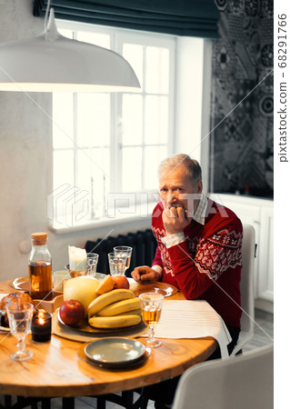 old unhappy man is sitting at the table old unhappy man is sitting at the table 68291766