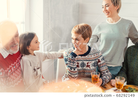 little adorable girl talking with her mother and aunt during the holiday 68292149