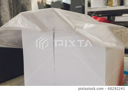 stacks of printed sheets of cardboard on wooden pallets closeup. printing industry. 68292241