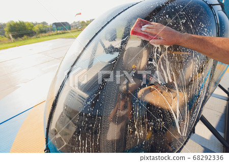 Detail of Helicopter Engineering on a beautiful blue sky,Military Helicopter fighter cockpit. Outdoor wash with sponge and foam. 68292336