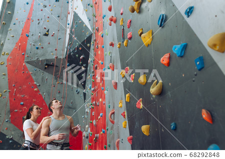thoughtful man and woman analyzing the route of climbing thoughtful man and woman analyzing the route of climbing 68292848