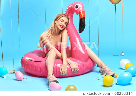 awesome beautiful girl in trendy clothes sitting on the flamingo awesome beautiful girl in trendy clothes sitting on the flamingo 68293314