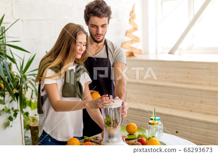 young man and woman have gathered fresh fruits from the gardern young man and woman have gathered fresh fruits from the gardern 68293673