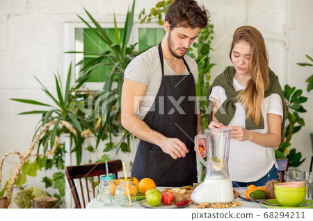young pleasant people preparing fruits for blending 68294211