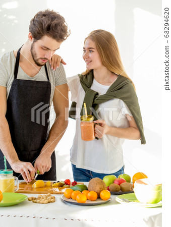 young joyful girl is proud of her hardworking boyfriend young joyful girl is proud of her hardworking boyfriend 68294620