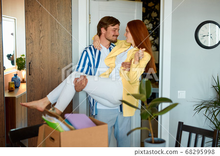 beautiful couple is having fun with keys from new house at moving day 68295998