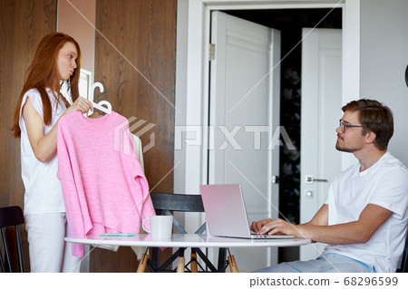 young woman ask opinion of working husband 68296599