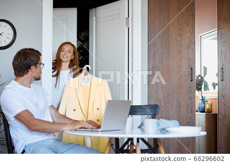 woman choose clothes for party, ask help of husband woman choose clothes for party, ask help of husband 68296602