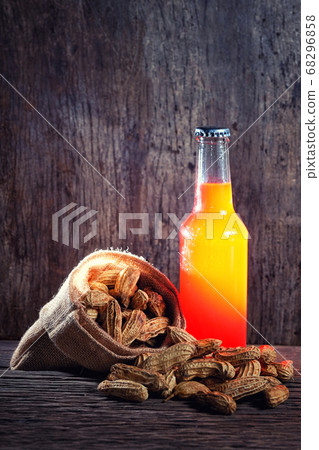 Peanuts and a Beer in red bottle in wood 68296858