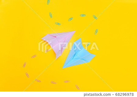 Minimalism, two blue and pink paper airplanes with paved path on yellow background, flat lay copy space Minimalism, two blue and pink paper airplanes with paved path on yellow background, flat lay copy space 68296978