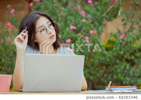 the woman is working in the garden 68303346