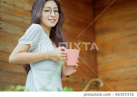 woman enjoying a cup of coffee in the morning 68303358