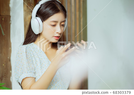 woman is playing game and listening to music 68303379