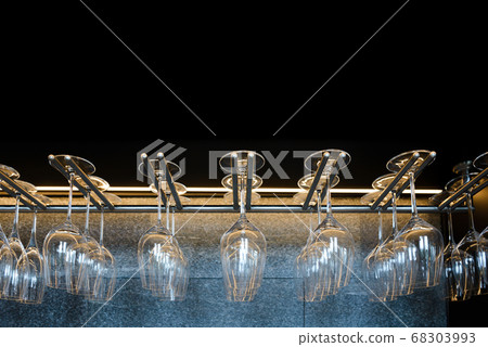 empty wine glasses hanging on rack in bar empty wine glasses hanging on rack in bar 68303993