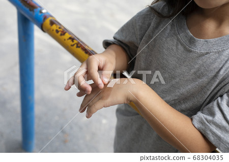 Child sticking a bandage Child sticking a bandage 68304035