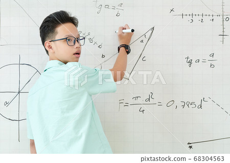 Schoolboy solving geometry task Schoolboy solving geometry task 68304563