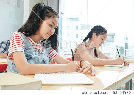 Students writing in copybooks Students writing in copybooks 68304570
