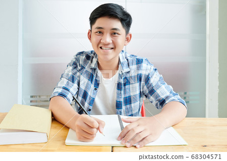 Schoolboy writing in copybook Schoolboy writing in copybook 68304571