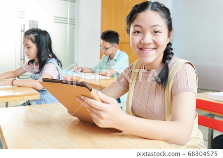 Schoolgirl with tablet computer Schoolgirl with tablet computer 68304575
