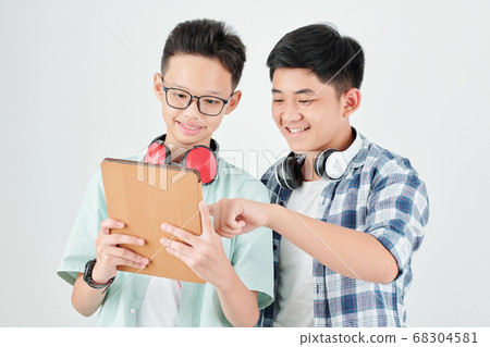 Boys discussing new app Boys discussing new app 68304581
