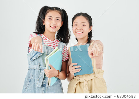 Cheerful classmates with textbooks Cheerful classmates with textbooks 68304588