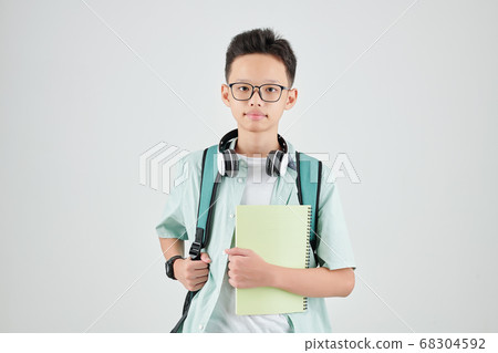 Serious schoolboy with textbook Serious schoolboy with textbook 68304592