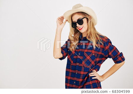 Woman in plaid shirt and hat Woman in plaid shirt and hat 68304599