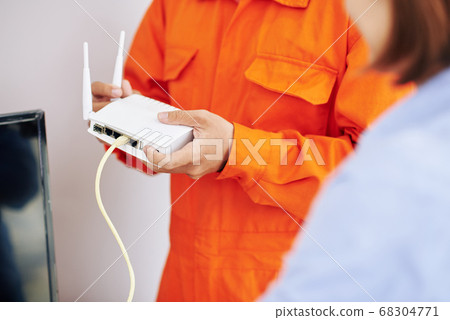 Electrician explaining how to use wi-fi router Electrician explaining how to use wi-fi router 68304771