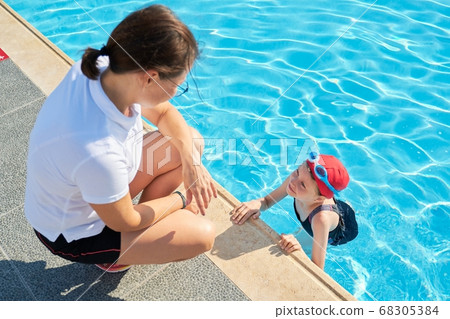 Sports girl child in outdoor pool talking with mother Sports girl child in outdoor pool talking with mother 68305384