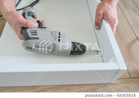 Closeup of workers hand with professional tools and furniture details 68305638