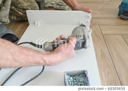 Closeup of workers hand with professional tools and furniture details 68305639
