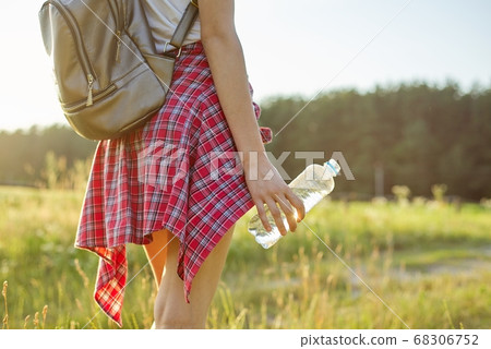 Hand of young woman holding bottle of water 68306752