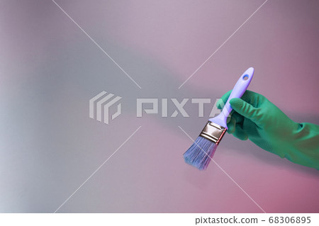 Beutiful Hand holding paint brush in the in neon Beutiful Hand holding paint brush in the in neon 68306895