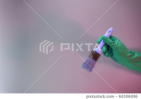 Beutiful Hand holding paint brush in the in neon Beutiful Hand holding paint brush in the in neon 68306896