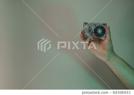 Hand holding audio cassette tape in the color 68306931